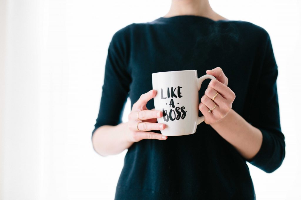 picture of a GIRLBOSS holding a white mug. 'LIKE A BOSS' is written on the mug.