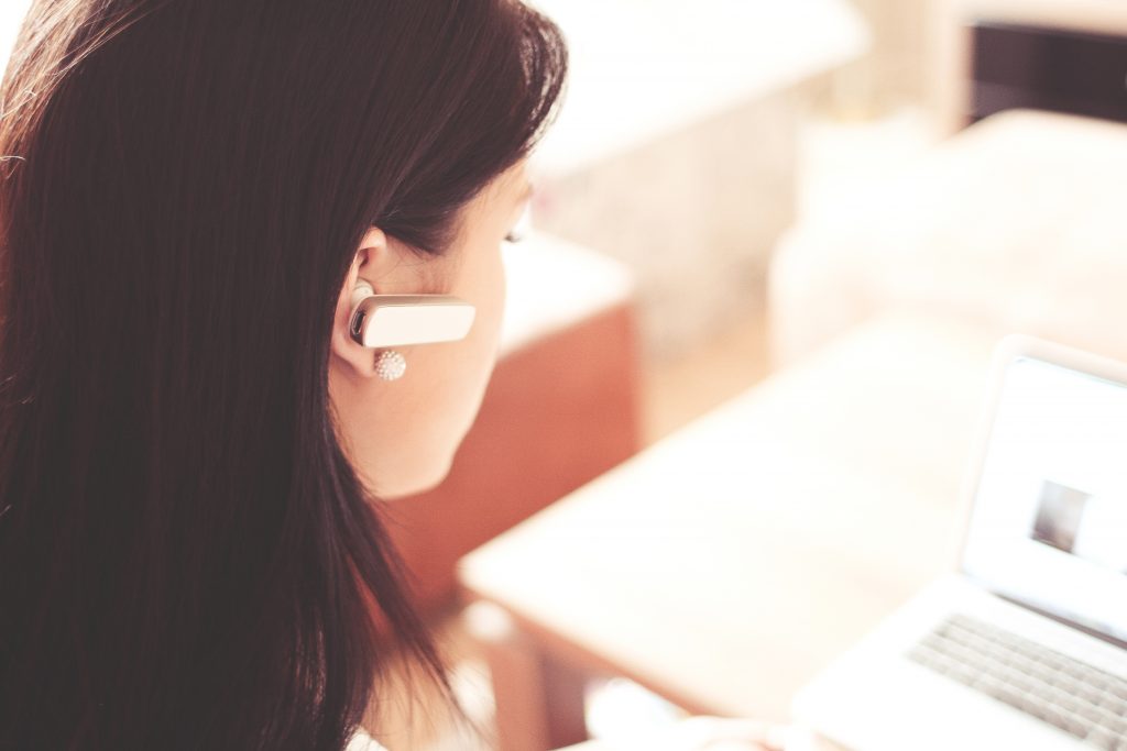 Busy, elegant woman (GirtlBoss) with headset.