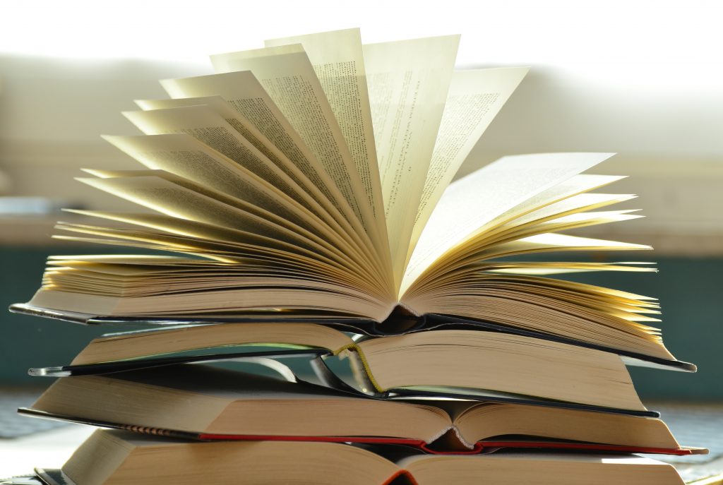 a stack of books representing the collecting of materials for the study plan